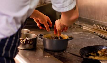 A chef at ABar Bistro in Portsmouth prepares a meal