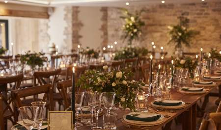 Sparkling glasses and white flower arrangements on wooden tables