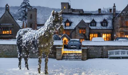 Ellenborough Park glows with lights, surrounded by a blanket of snow
