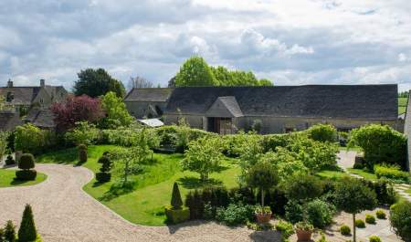 One of the landscaped gardens at Thyme with Cotswold stone buildings