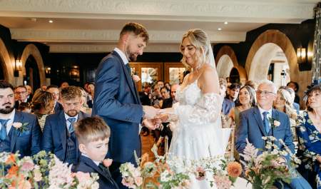 A bride and groom exchange rings