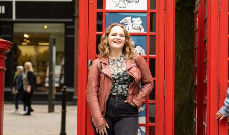 Ladies in Cheltenham, posing by phone boxes on Promenade
