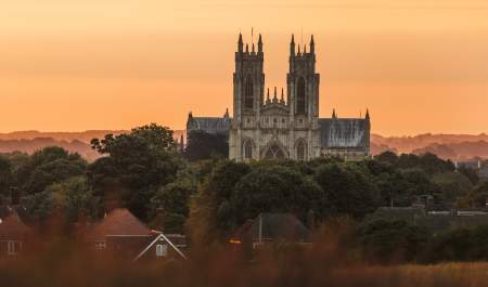 Beverley minster in the forefront with the sunset behind.