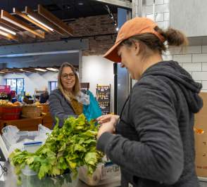 Customer and worker at Prairieland Market in Salina, Kansas