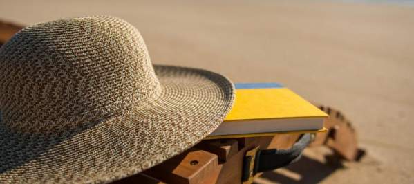 Bethany Beach hat and lounge chair with book