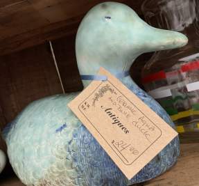 duck statue on shelf