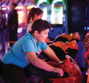 boy playing in an arcade