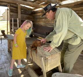 girl at a demonstration about pioneer life
