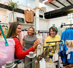 three ladies shopping in a boutique