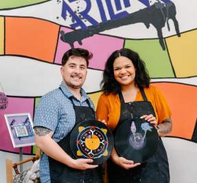 couple posing with painted vinyl records