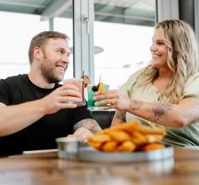 couple toasting before dinner at a restaurant