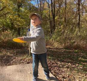 boy playing disc golf