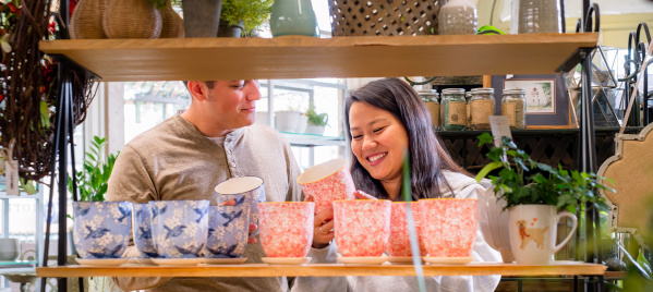 couple looking at colorful plant pots