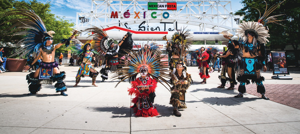 traditional Mexican dance in front of Mexican Fiesta festival grounds main gate