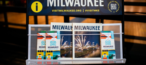 A display of Visit Milwaukee collateral including official visitors guides and maps.