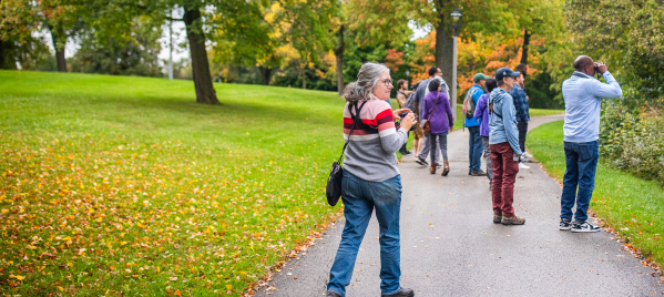 a woman with binoculars birding in a park