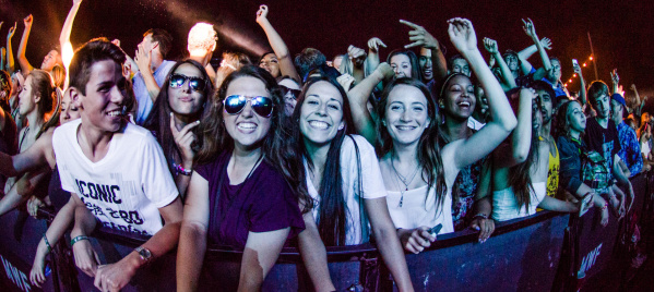 A group of people at the front row of a music performance