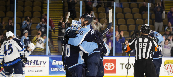 Admirals players hugging and cheering