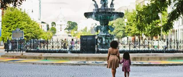 A woman and her daughter stand in front of the fountain in Montgomery, Alabama.