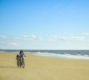 Family biking on East Beach