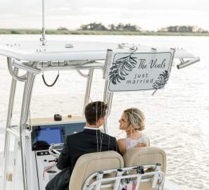 Bride and groom on a boat in the Golden Isles