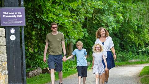A family walking along the Community Path between Blenheim Palace and Hanborough train station