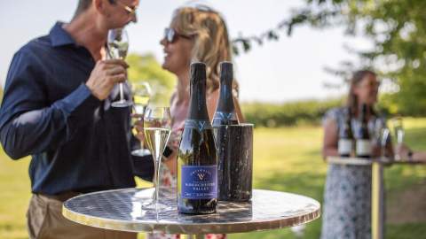 A couple enjoying a glass of wine at Woodchester Valley Vineyard