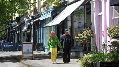 Shoppers in Montpellier District Cheltenham, walking past row of shops.