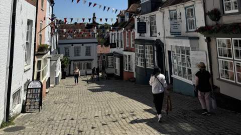 People walking down the cobbled street of Quay Hill in Lymington in the New Forest