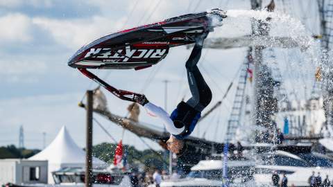 Man doing back flip on a jet ski at Southampton International Boat Show