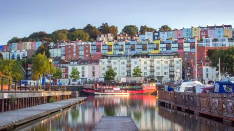 Terraced house painted a rainbow of colours overlook the SS Great Britain and the Floating Harbour, in Bristol
