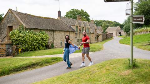 A couple holding hands walking in Notgrove
