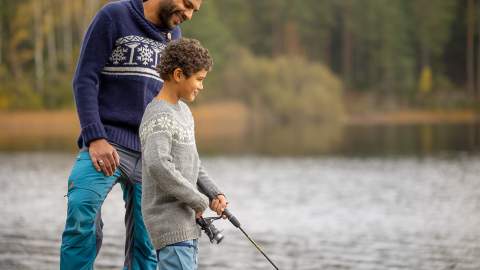 Man and boy fishing by a lake
