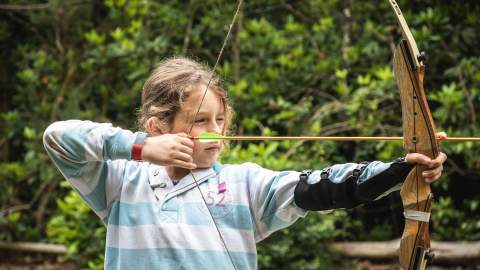 Girl doing archery at New Forest Activities - Activities Hero