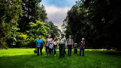 A tour group led by a guide at Westonbirt Arboretum