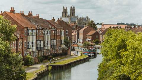 A couple taking a stroll along Beverley Beck with the Minster in the background.