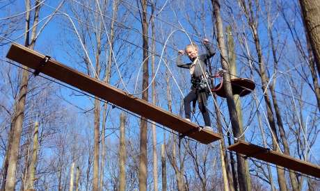 Girl balancing on aerial ropes and boards at Tree Trekkers in Frederick, MD