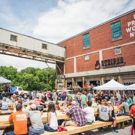 A crowd enjoys a festival at Taylors Mill, just outside the doors of 13 Stripes Brewery in Taylors, SC.