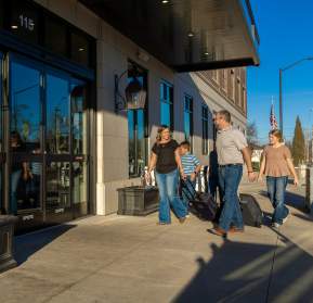 A family enters the Homewood Suites hotel