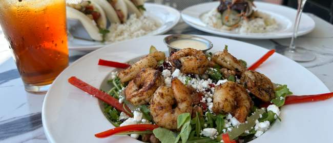a salad with shrimp, boa bun tacos, and steak from Oak and Palm in Sunset Beach, NC