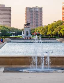 People walking around Hermann Park on a sunny afternoon