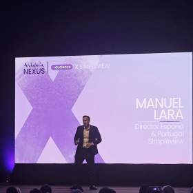 Manuel Lara of Simpleview, now part of Granicus, presenting on stage.