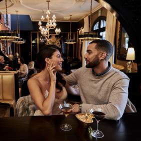 Couple sharing drinks at an eclectic hotel bar
