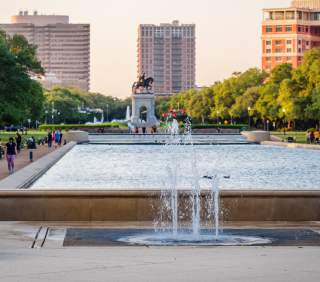 People walking around Hermann Park on a sunny afternoon