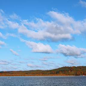 A person kayaking on Monroe Lake during fall