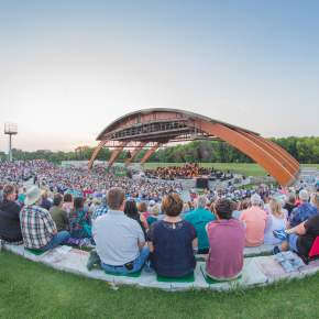 outdoor concert venue along the wooded riverfront