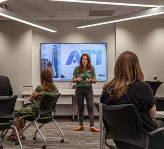 Teacher stands in front of class during Austin Tourism Insider training course
