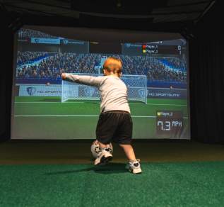 Child Kicking Ball in Simulator Bay