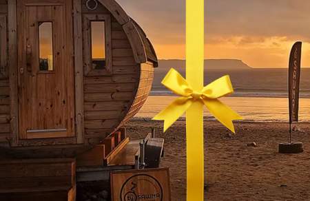 A round sauna shed on a beach.