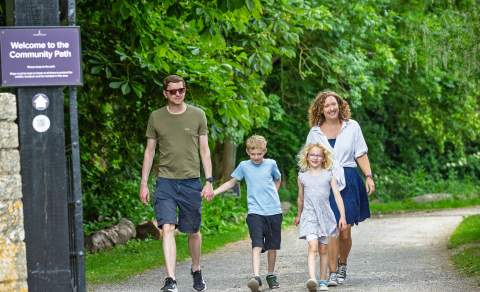 A family walking along the Community Path between Blenheim Palace and Hanborough train station